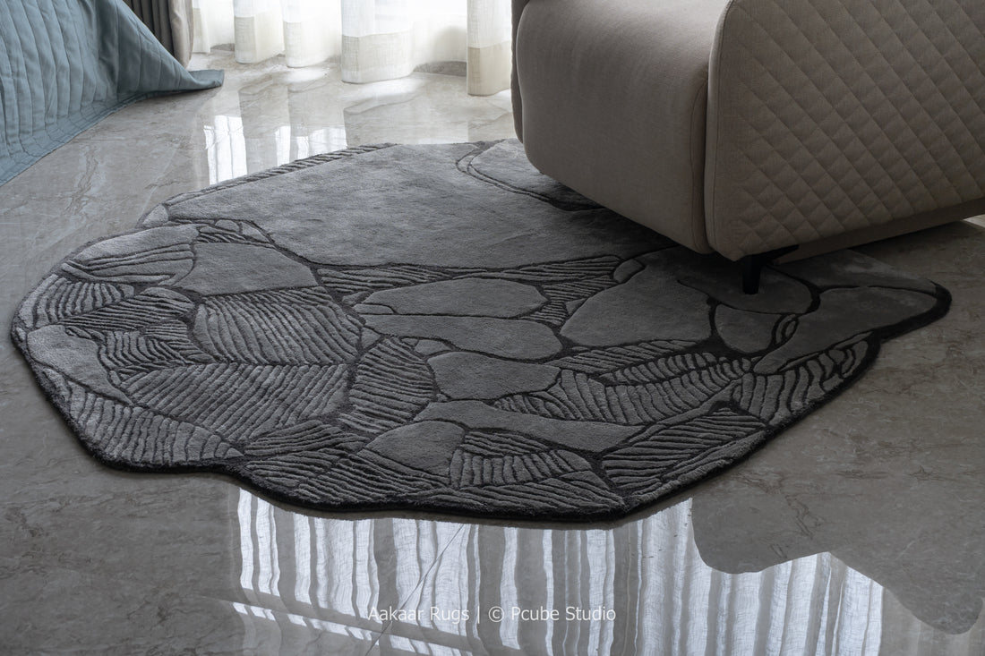 Round textured rug on a polished floor with a sofa in the background